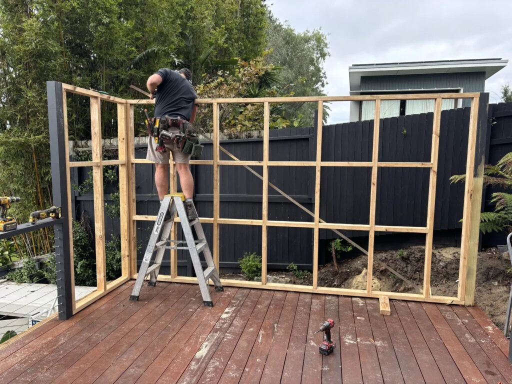 Outdoor kitchen with BBQ, fridge and sink under insulated panel roofing, Coogee