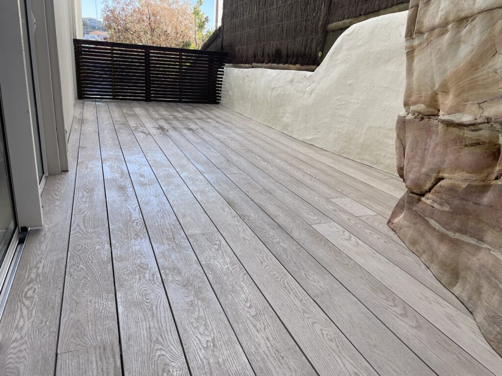 Coogee low deck in Millboard Limed Oak on pedestals