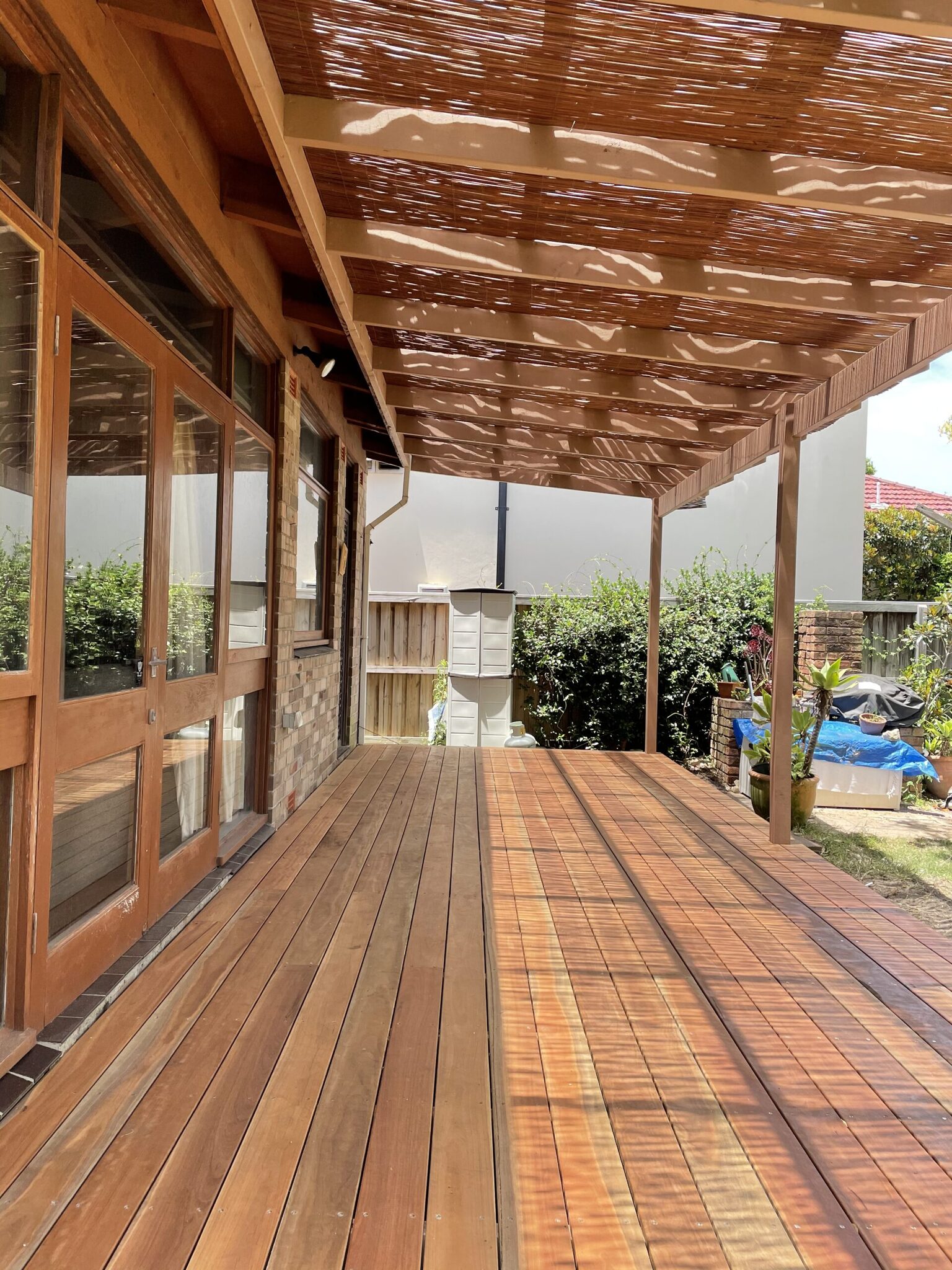 Spotted Gum timber deck beneath a matching slatted timber pergola