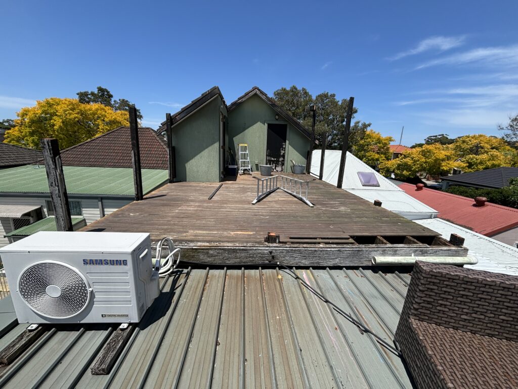 Deck boards lifted during demolition, Mascot rooftop