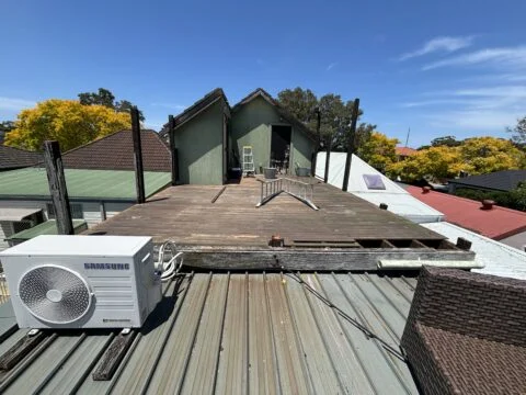 Deck boards lifted during demolition, Mascot rooftop