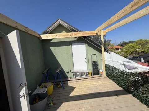 EzGlaze pergola construction begins on Mascot Trex deck
