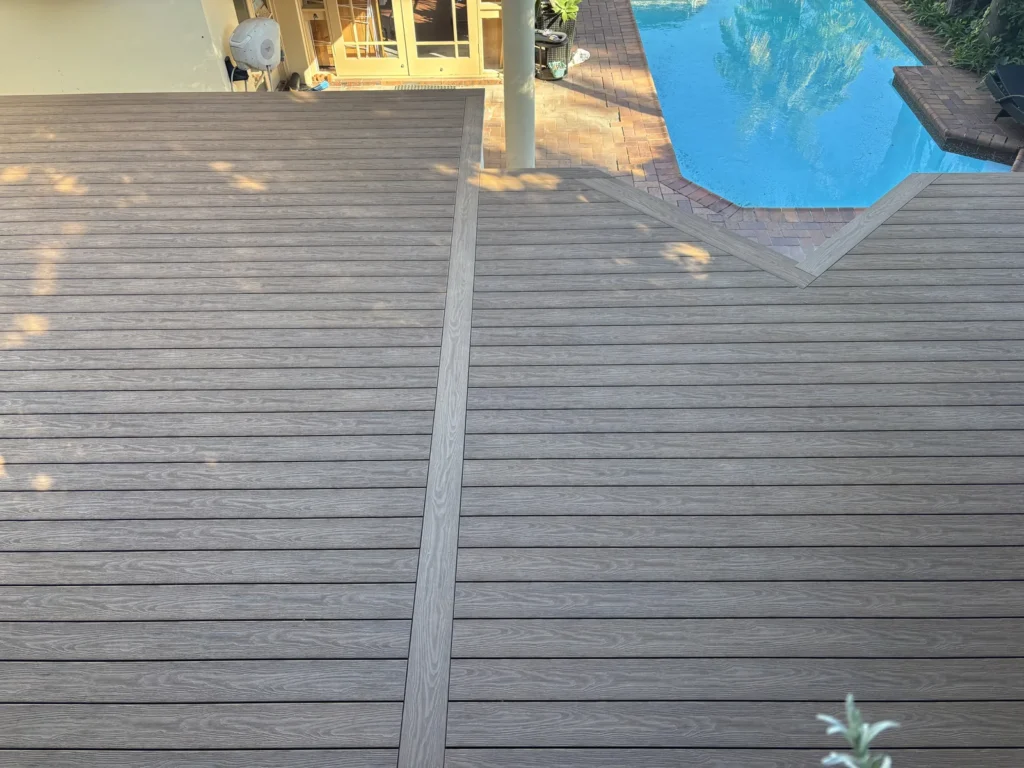 Curved edge of the finished Double Bay deck against the log pole retaining wall