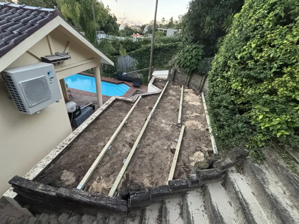 Curved log pole retaining wall exposed after the old Double Bay deck was removed