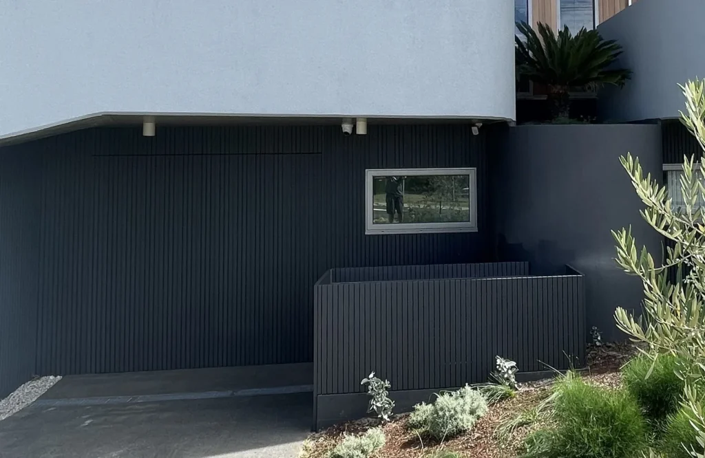 Finished bin and scooter store at Mons Avenue Maroubra painted to match the garage door so it reads as wall from the street