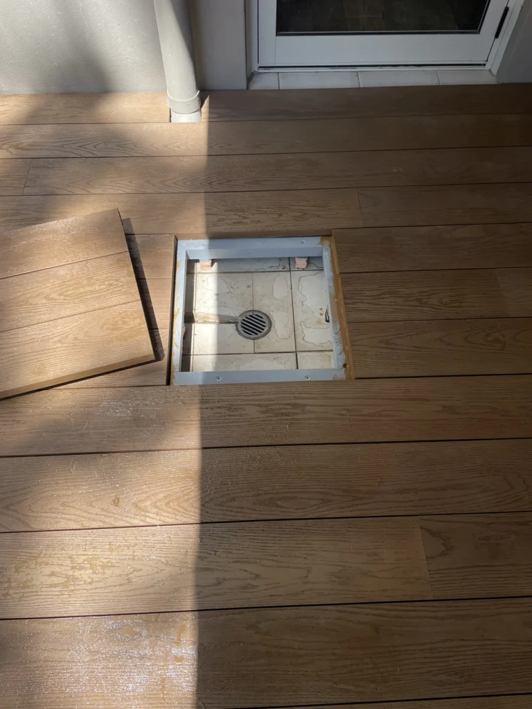 Access hatch open over original tiles and drain, Rose Bay Millboard