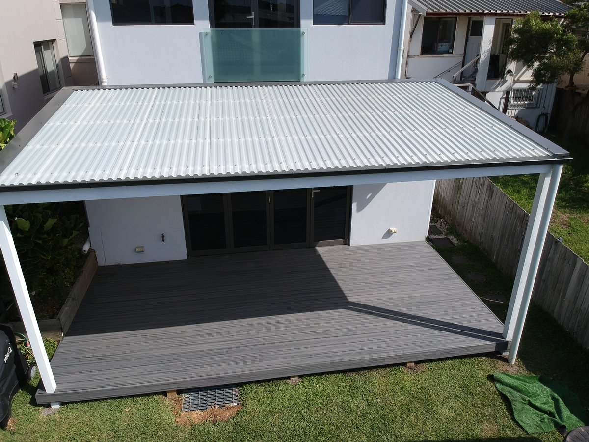 White-framed polycarbonate pergola over a charcoal composite deck
